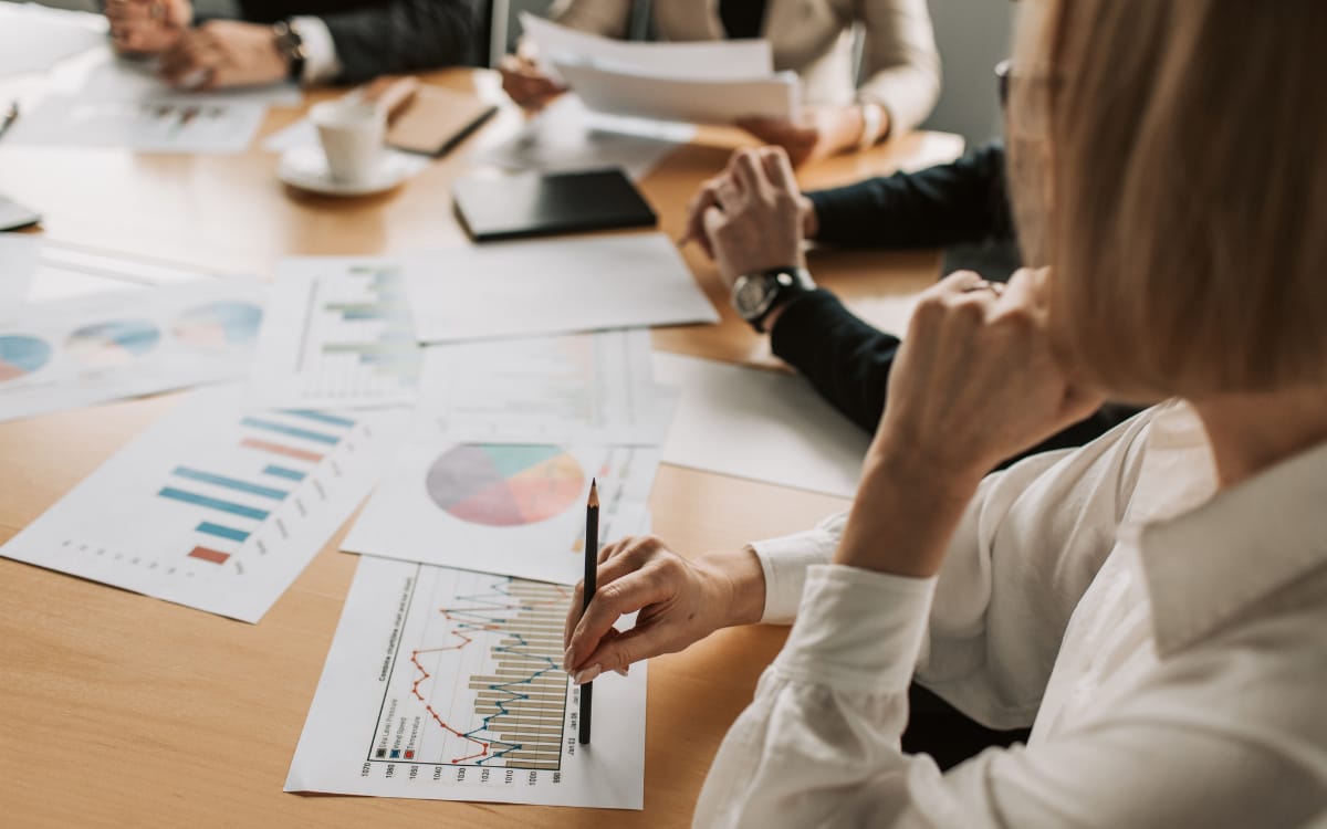 A nonprofit board reviewing printed financial reports and charts during a meeting